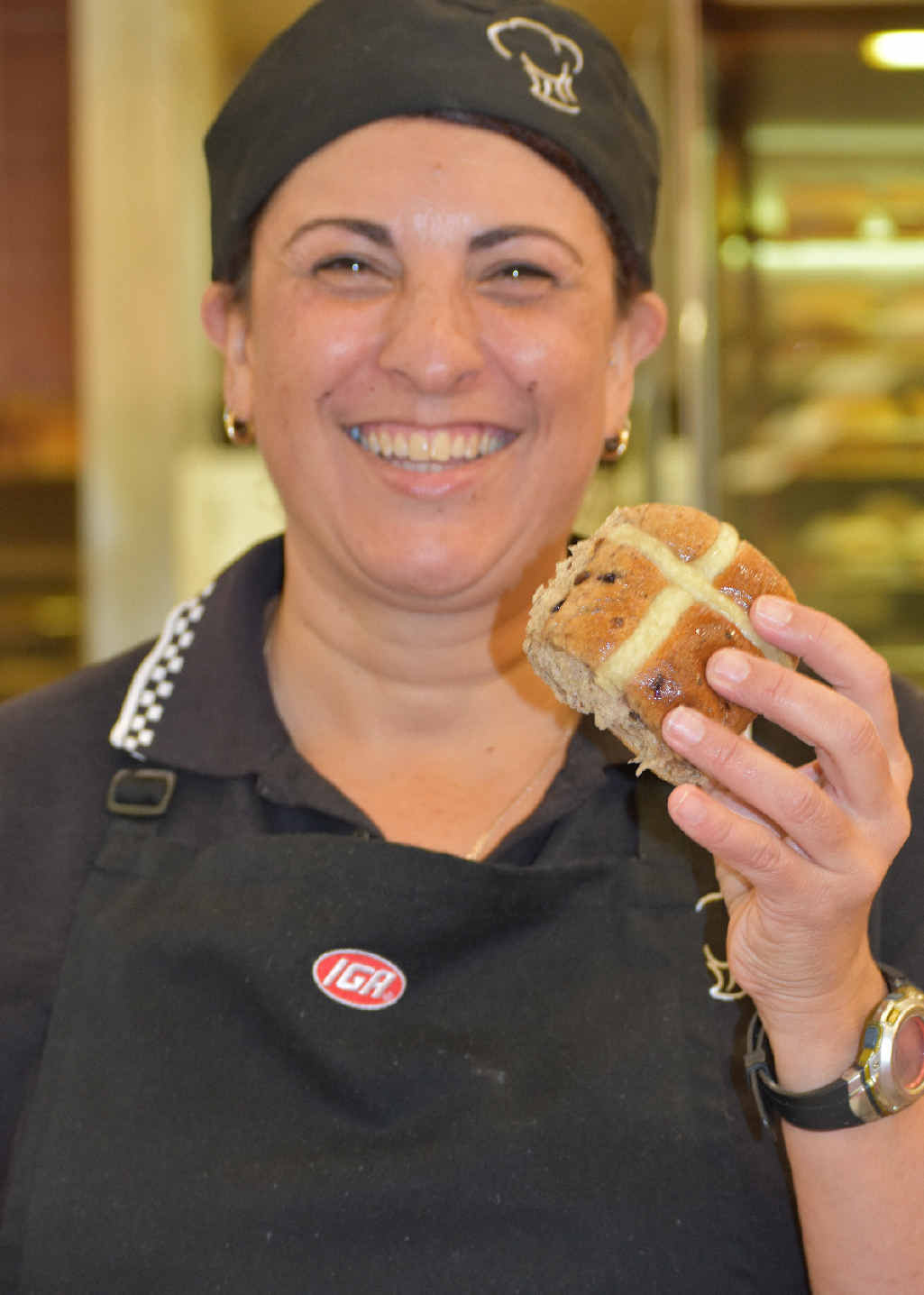 EASTER READY: Spano’s IGA Warwick bakery manager Jacqui Swift-Ross with one of the first hot cross buns of the year in store yesterday.